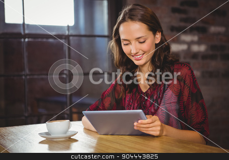 To use this stock image in your creative project, please select the size you need over to the right and click the "Add to Cart" button.
Your downloaded image will come with the Cutcaster watermark removed so don’t worry about the watermark you see on this page. Smiling brunette having coffee and using tablet stock photo, Smiling brunette having coffee and using tablet at coffee shop by Wavebreak Media
