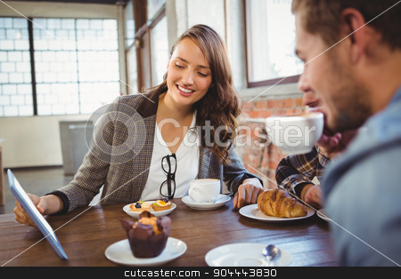 To use this stock image in your creative project, please select the size you need over to the right and click the "Add to Cart" button.
Your downloaded image will come with the Cutcaster watermark removed so don’t worry about the watermark you see on this page. Smiling friends enjoying coffee and looking at tablet stock photo, Smiling friends enjoying coffee and looking at tablet at coffee shop by Wavebreak Media