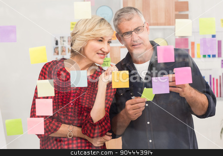 To use this stock image in your creative project, please select the size you need over to the right and click the "Add to Cart" button.
Your downloaded image will come with the Cutcaster watermark removed so don’t worry about the watermark you see on this page. Puzzled business team looking post its on the wall stock photo, Puzzled business team looking post its on the wall in the office by Wavebreak Media