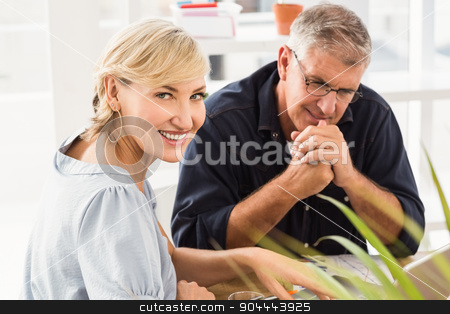To use this stock image in your creative project, please select the size you need over to the right and click the "Add to Cart" button.
Your downloaded image will come with the Cutcaster watermark removed so don’t worry about the watermark you see on this page. Smiling business team working on laptop stock photo, Portrait of smiling business team working on laptop at office by Wavebreak Media