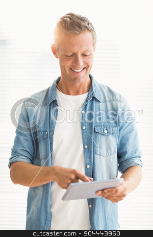 To use this stock image in your creative project, please select the size you need over to the right and click the "Add to Cart" button.
Your downloaded image will come with the Cutcaster watermark removed so don’t worry about the watermark you see on this page. Smiling businessman scrolling on a tablet stock photo, Smiling businessman scrolling on a tablet at the office by Wavebreak Media