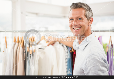 To use this stock image in your creative project, please select the size you need over to the right and click the "Add to Cart" button.
Your downloaded image will come with the Cutcaster watermark removed so don’t worry about the watermark you see on this page. Smiling man browsing clothes stock photo, Portrait of smiling man browsing clothes in clothing store by Wavebreak Media