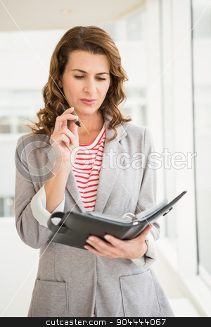 To use this stock image in your creative project, please select the size you need over to the right and click the "Add to Cart" button.
Your downloaded image will come with the Cutcaster watermark removed so don’t worry about the watermark you see on this page. Casual businesswoman checking her planner stock photo, Casual businesswoman checking her planner in the office by Wavebreak Media