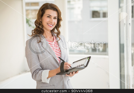 To use this stock image in your creative project, please select the size you need over to the right and click the "Add to Cart" button.
Your downloaded image will come with the Cutcaster watermark removed so don’t worry about the watermark you see on this page. Smiling businesswoman writing in planner stock photo, Portrait of smiling businesswoman writing in planner in the office by Wavebreak Media