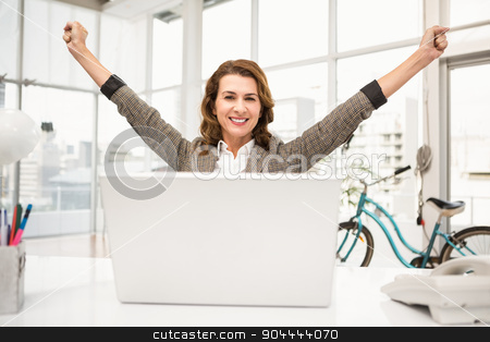 To use this stock image in your creative project, please select the size you need over to the right and click the "Add to Cart" button.
Your downloaded image will come with the Cutcaster watermark removed so don’t worry about the watermark you see on this page. Smiling casual businesswoman celebrating success stock photo, Portrait of smiling casual businesswoman celebrating success in the office by Wavebreak Media