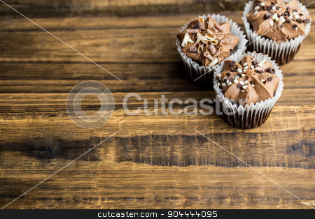 To use this stock image in your creative project, please select the size you need over to the right and click the "Add to Cart" button.
Your downloaded image will come with the Cutcaster watermark removed so don’t worry about the watermark you see on this page. Chocolate cupcakes on a table stock photo, Chocolate cupcakes on a table shot in studio by Wavebreak Media