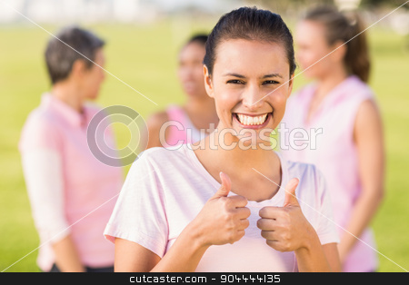 To use this stock image in your creative project, please select the size you need over to the right and click the "Add to Cart" button.
Your downloaded image will come with the Cutcaster watermark removed so don’t worry about the watermark you see on this page. Smiling brunette wearing pink for breast cancer in front of frie stock photo, Portrait of smiling brunette wearing pink for breast cancer in front of friends in parkland by Wavebreak Media