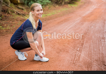 To use this stock image in your creative project, please select the size you need over to the right and click the "Add to Cart" button.
Your downloaded image will come with the Cutcaster watermark removed so don’t worry about the watermark you see on this page. Smiling athletic blonde tying her shoelace stock photo, Portrait of smiling athletic blonde tying her shoelace in the nature by Wavebreak Media