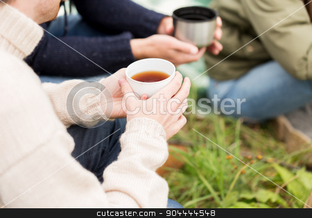 To use this stock image in your creative project, please select the size you need over to the right and click the "Add to Cart" button.
Your downloaded image will come with the Cutcaster watermark removed so don’t worry about the watermark you see on this page. close up of hikers drinking tea from cups at camp stock photo, adventure, travel, tourism and people concept - close up of hikers drinking tea from cups at camp by Syda Productions