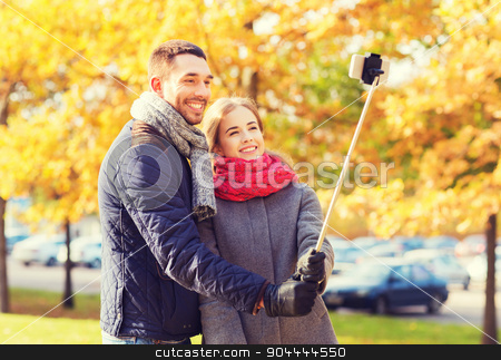To use this stock image in your creative project, please select the size you need over to the right and click the "Add to Cart" button.
Your downloaded image will come with the Cutcaster watermark removed so don’t worry about the watermark you see on this page. smiling couple with smartphone in autumn park stock photo, love, relationship, family and people concept - smiling couple hugging and taking selfie with smartphone and monopod in autumn park by Syda Productions