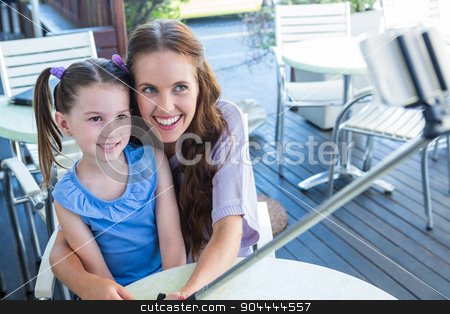 To use this stock image in your creative project, please select the size you need over to the right and click the "Add to Cart" button.
Your downloaded image will come with the Cutcaster watermark removed so don’t worry about the watermark you see on this page. Mother and daughter using selfie stick at cafe terrace stock photo, Mother and daughter using selfie stick at cafe terrace on a sunny day by Wavebreak Media