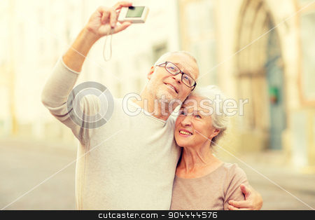 To use this stock image in your creative project, please select the size you need over to the right and click the "Add to Cart" button.
Your downloaded image will come with the Cutcaster watermark removed so don’t worry about the watermark you see on this page. senior couple photographing on city street stock photo, age, tourism, travel, technology and people concept - senior couple with camera taking selfie on street by Syda Productions