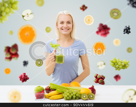 To use this stock image in your creative project, please select the size you need over to the right and click the "Add to Cart" button.
Your downloaded image will come with the Cutcaster watermark removed so don’t worry about the watermark you see on this page. smiling woman drinking juice or shake at home stock photo, healthy eating, vegetarian food, diet, detox and people concept - smiling woman drinking green vegetable juice or shake from glass over fruits and berries on gray background by Syda Productions