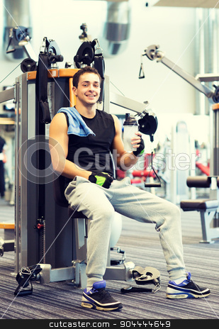 To use this stock image in your creative project, please select the size you need over to the right and click the "Add to Cart" button.
Your downloaded image will come with the Cutcaster watermark removed so don’t worry about the watermark you see on this page. smiling man exercising on gym machine stock photo, sport, fitness, equipment, lifestyle and people concept - smiling man exercising on gym machine by Syda Productions