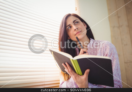 To use this stock image in your creative project, please select the size you need over to the right and click the "Add to Cart" button.
Your downloaded image will come with the Cutcaster watermark removed so don’t worry about the watermark you see on this page. Pretty brunette studying beside window stock photo, Pretty brunette studying beside window in a bright room by Wavebreak Media