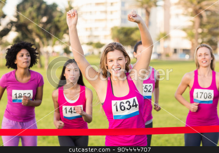 To use this stock image in your creative project, please select the size you need over to the right and click the "Add to Cart" button.
Your downloaded image will come with the Cutcaster watermark removed so don’t worry about the watermark you see on this page. Cheering blonde winning breast cancer marathon stock photo, Portrait of cheering blonde winning breast cancer marathon in parkland by Wavebreak Media