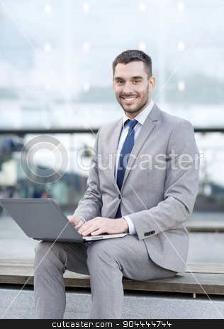 To use this stock image in your creative project, please select the size you need over to the right and click the "Add to Cart" button.
Your downloaded image will come with the Cutcaster watermark removed so don’t worry about the watermark you see on this page. smiling businessman working with laptop outdoors stock photo, business, education, technology and people concept - smiling businessman working with laptop computer on city street by Syda Productions