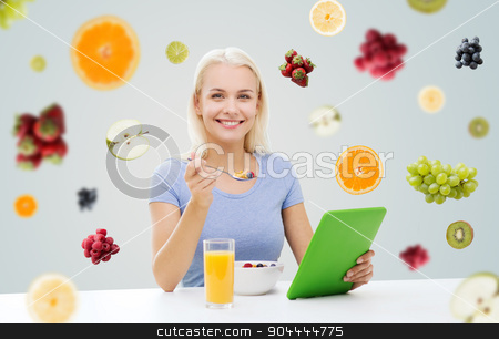 To use this stock image in your creative project, please select the size you need over to the right and click the "Add to Cart" button.
Your downloaded image will come with the Cutcaster watermark removed so don’t worry about the watermark you see on this page. smiling woman with tablet pc eating breakfast stock photo, healthy eating, dieting and people concept - smiling young woman with tablet pc computer eating breakfast over fruits and berries on gray background by Syda Productions