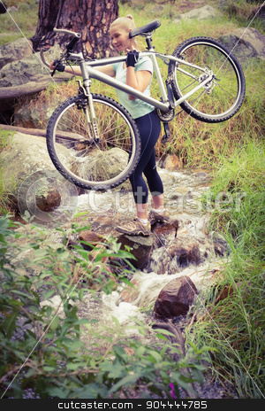 To use this stock image in your creative project, please select the size you need over to the right and click the "Add to Cart" button.
Your downloaded image will come with the Cutcaster watermark removed so don’t worry about the watermark you see on this page. Serious fit woman lifting her bike stock photo, Serious fit woman lifting her bike while crossing a river by Wavebreak Media
