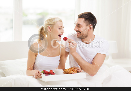 To use this stock image in your creative project, please select the size you need over to the right and click the "Add to Cart" button.
Your downloaded image will come with the Cutcaster watermark removed so don’t worry about the watermark you see on this page. happy couple having breakfast in bed at home stock photo, people, love, care and happiness concept - happy couple having breakfast in bed and eating strawberries at home by Syda Productions