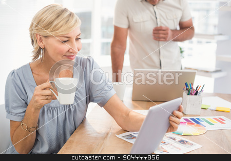 To use this stock image in your creative project, please select the size you need over to the right and click the "Add to Cart" button.
Your downloaded image will come with the Cutcaster watermark removed so don’t worry about the watermark you see on this page. Smiling businesswoman holding a tablet stock photo, Businesswoman holding a tablet and drinking coffee at office by Wavebreak Media