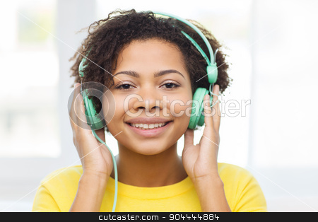 To use this stock image in your creative project, please select the size you need over to the right and click the "Add to Cart" button.
Your downloaded image will come with the Cutcaster watermark removed so don’t worry about the watermark you see on this page. happy woman with headphones listening to music stock photo, people, technology and leisure concept - happy african american young woman sitting on sofa with headphones listening to music at home by Syda Productions