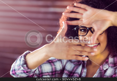 To use this stock image in your creative project, please select the size you need over to the right and click the "Add to Cart" button.
Your downloaded image will come with the Cutcaster watermark removed so don’t worry about the watermark you see on this page. Attractive hipster taking picture with hands stock photo, Portrait of attractive hipster taking picture with hands against red brick background by Wavebreak Media