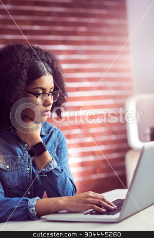 To use this stock image in your creative project, please select the size you need over to the right and click the "Add to Cart" button.
Your downloaded image will come with the Cutcaster watermark removed so don’t worry about the watermark you see on this page. Casual businesswoman using laptop and smartwatch stock photo, Casual businesswoman using laptop and smartwatch in her office by Wavebreak Media