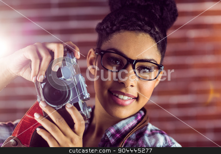 To use this stock image in your creative project, please select the size you need over to the right and click the "Add to Cart" button.
Your downloaded image will come with the Cutcaster watermark removed so don’t worry about the watermark you see on this page. Portrait of a young hipster taking a picture stock photo, Portrait of a young hipster taking a picture against a brick wall by Wavebreak Media