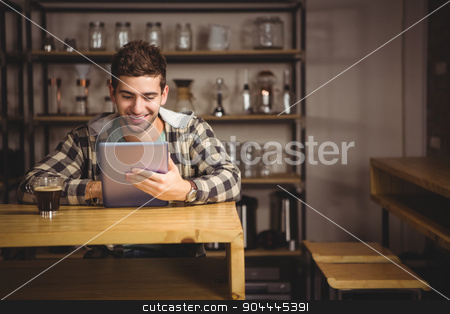To use this stock image in your creative project, please select the size you need over to the right and click the "Add to Cart" button.
Your downloaded image will come with the Cutcaster watermark removed so don’t worry about the watermark you see on this page. Smiling hipster having coffee and using tablet computer stock photo, Smiling hipster having coffee and using tablet computer at coffee shop by Wavebreak Media