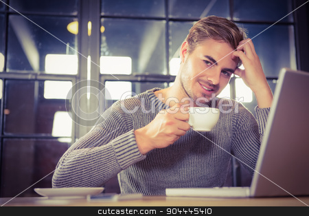 To use this stock image in your creative project, please select the size you need over to the right and click the "Add to Cart" button.
Your downloaded image will come with the Cutcaster watermark removed so don’t worry about the watermark you see on this page. Handsome man smiling and drinking coffee stock photo, Portrait of handsome man smiling and drinking coffee at coffee shop by Wavebreak Media