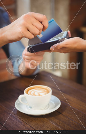 To use this stock image in your creative project, please select the size you need over to the right and click the "Add to Cart" button.
Your downloaded image will come with the Cutcaster watermark removed so don’t worry about the watermark you see on this page. Male customer paying with credit card stock photo, Male customer paying with credit card at coffee shop by Wavebreak Media