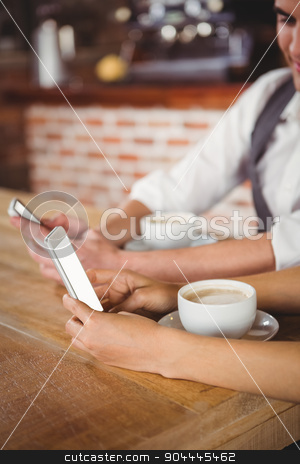 To use this stock image in your creative project, please select the size you need over to the right and click the "Add to Cart" button.
Your downloaded image will come with the Cutcaster watermark removed so don’t worry about the watermark you see on this page. Cute couple sitting in cafe looking at smartphone stock photo, Cute couple sitting in cafe looking at smartphone on a sunny day by Wavebreak Media