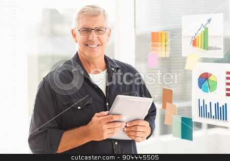 To use this stock image in your creative project, please select the size you need over to the right and click the "Add to Cart" button.
Your downloaded image will come with the Cutcaster watermark removed so don’t worry about the watermark you see on this page. Smiling businessman holding a digital tablet stock photo, Portrait of a happy businessman holding a digital tablet at office by Wavebreak Media