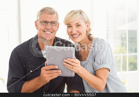 To use this stock image in your creative project, please select the size you need over to the right and click the "Add to Cart" button.
Your downloaded image will come with the Cutcaster watermark removed so don’t worry about the watermark you see on this page. Smiling business team working over a tablet stock photo, Portrait of a smiling business team working over a tablet at office by Wavebreak Media