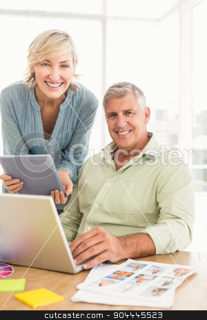 To use this stock image in your creative project, please select the size you need over to the right and click the "Add to Cart" button.
Your downloaded image will come with the Cutcaster watermark removed so don’t worry about the watermark you see on this page. Smiling business team talking over a laptop stock photo, Portrait of a business team talking over a laptop and tablet at office by Wavebreak Media