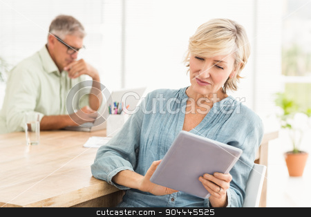 To use this stock image in your creative project, please select the size you need over to the right and click the "Add to Cart" button.
Your downloaded image will come with the Cutcaster watermark removed so don’t worry about the watermark you see on this page. Attentive businesswoman working on a tablet stock photo, Attentive businesswoman working on a tablet at the office by Wavebreak Media