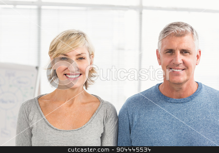 To use this stock image in your creative project, please select the size you need over to the right and click the "Add to Cart" button.
Your downloaded image will come with the Cutcaster watermark removed so don’t worry about the watermark you see on this page. Smiling business colleagues looking at the camera stock photo, Portrait of a smiling standing business colleagues at the office by Wavebreak Media