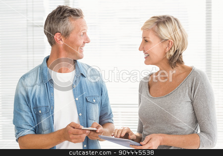 To use this stock image in your creative project, please select the size you need over to the right and click the "Add to Cart" button.
Your downloaded image will come with the Cutcaster watermark removed so don’t worry about the watermark you see on this page. Business colleagues working on tablet and phone stock photo, Smiling business colleagues working on tablet and phone at office by Wavebreak Media
