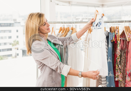 To use this stock image in your creative project, please select the size you need over to the right and click the "Add to Cart" button.
Your downloaded image will come with the Cutcaster watermark removed so don’t worry about the watermark you see on this page. Smiling woman browsing clothes stock photo, Smiling woman browsing clothes in clothing store by Wavebreak Media