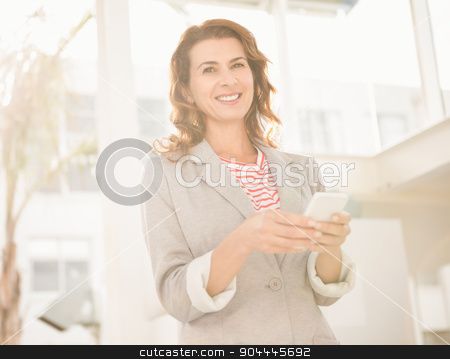 To use this stock image in your creative project, please select the size you need over to the right and click the "Add to Cart" button.
Your downloaded image will come with the Cutcaster watermark removed so don’t worry about the watermark you see on this page. Smiling casual businesswoman holding smartphone stock photo, Portrait of smiling casual businesswoman holding smartphone in the office by Wavebreak Media
