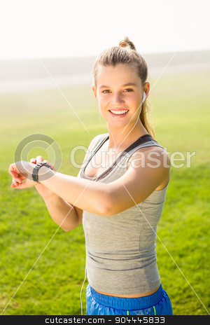 To use this stock image in your creative project, please select the size you need over to the right and click the "Add to Cart" button.
Your downloaded image will come with the Cutcaster watermark removed so don’t worry about the watermark you see on this page. Smiling sporty blonde using smart watch stock photo, Portrait of smiling sporty blonde using smart watch in parkland by Wavebreak Media
