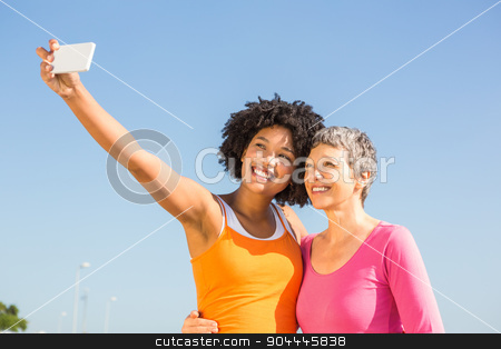 To use this stock image in your creative project, please select the size you need over to the right and click the "Add to Cart" button.
Your downloaded image will come with the Cutcaster watermark removed so don’t worry about the watermark you see on this page. Two smiling sporty women taking selfies stock photo, Two smiling sporty women taking selfies at promenade by Wavebreak Media