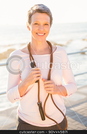To use this stock image in your creative project, please select the size you need over to the right and click the "Add to Cart" button.
Your downloaded image will come with the Cutcaster watermark removed so don’t worry about the watermark you see on this page. Smiling sporty woman with skipping rope stock photo, Portrait of smiling sporty woman with skipping rope at promenade by Wavebreak Media
