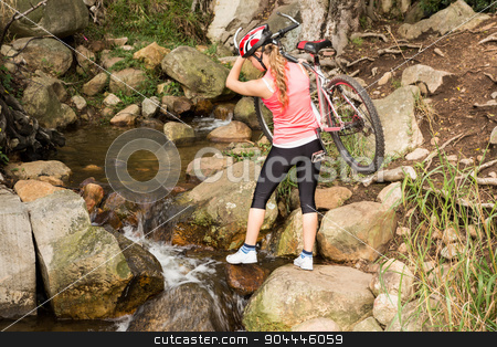 To use this stock image in your creative project, please select the size you need over to the right and click the "Add to Cart" button.
Your downloaded image will come with the Cutcaster watermark removed so don’t worry about the watermark you see on this page. Blonde athlete carrying her mountain bike over stream stock photo, Blonde athlete carrying her mountain bike over stream in the nature by Wavebreak Media