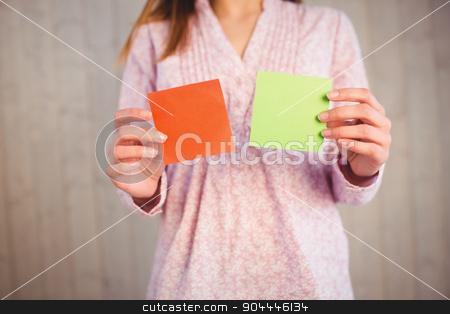 To use this stock image in your creative project, please select the size you need over to the right and click the "Add to Cart" button.
Your downloaded image will come with the Cutcaster watermark removed so don’t worry about the watermark you see on this page. Woman holding green and orange cards stock photo, Woman holding green and orange cards on wooden planks background by Wavebreak Media