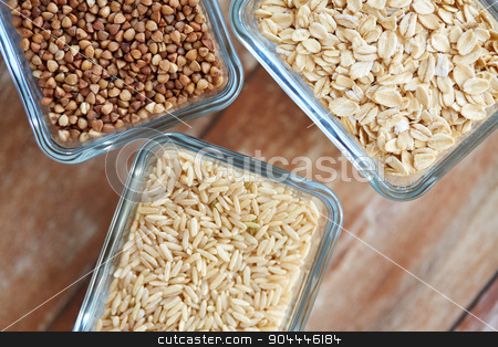 To use this stock image in your creative project, please select the size you need over to the right and click the "Add to Cart" button.
Your downloaded image will come with the Cutcaster watermark removed so don’t worry about the watermark you see on this page. close up of grain in glass bowls on wooden table stock photo, food, agriculture, cereals and healthy eating concept - close up of buckwheat, oatmeal and rice grain on wooden table by Syda Productions