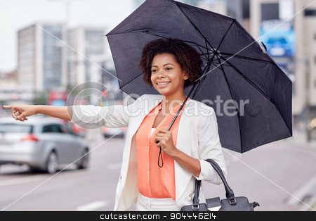 To use this stock image in your creative project, please select the size you need over to the right and click the "Add to Cart" button.
Your downloaded image will come with the Cutcaster watermark removed so don’t worry about the watermark you see on this page. happy african woman with umbrella catching taxi stock photo, business trip, transportation and people concept - young smiling african american woman with umbrella catching taxi at city street by Syda Productions