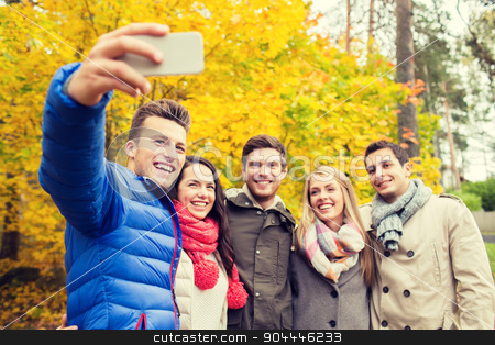 To use this stock image in your creative project, please select the size you need over to the right and click the "Add to Cart" button.
Your downloaded image will come with the Cutcaster watermark removed so don’t worry about the watermark you see on this page. smiling friends with smartphone in city park stock photo, season, people, technology and friendship concept - group of smiling friends with smartphone taking selfie in autumn park by Syda Productions