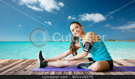 To use this stock image in your creative project, please select the size you need over to the right and click the "Add to Cart" button.
Your downloaded image will come with the Cutcaster watermark removed so don’t worry about the watermark you see on this page. smiling woman stretching leg on mat over sea stock photo, fitness, sport, training, technology and people concept - smiling woman with smartphone and earphones listening to music and stretching leg over sea and wooden berth at resort background by Syda Productions